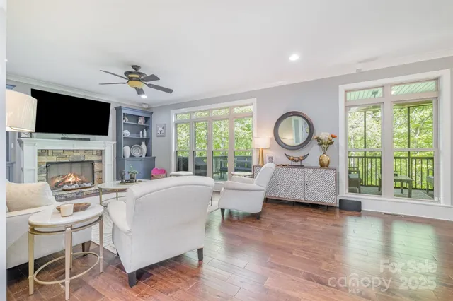 a living room with fireplace furniture and a flat screen tv