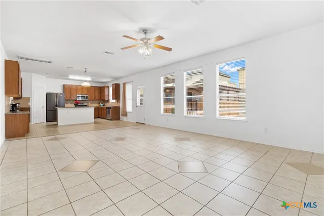 a view of a livingroom with furniture and chandelier fan