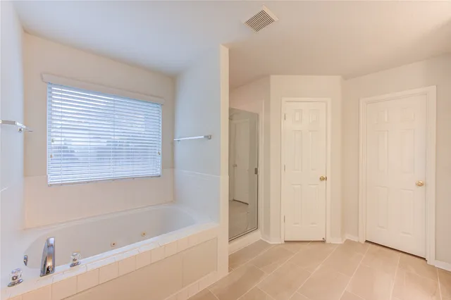 a bathroom with a bathtub and a shower
