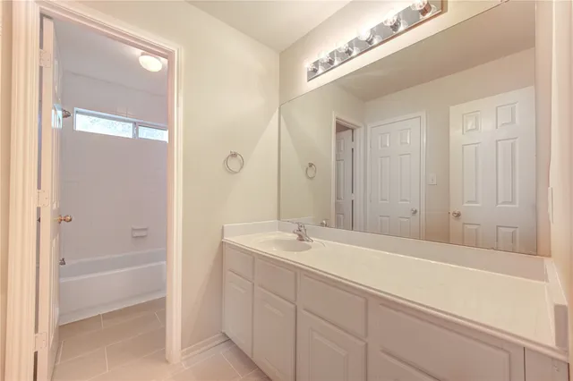 a view of a room with windows and ceiling fan