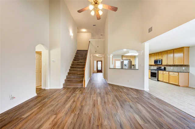 a view of a kitchen with wooden floor and a kitchen