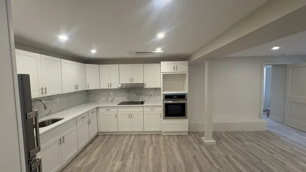 a kitchen with stainless steel appliances a sink a stove a refrigerator and cabinets