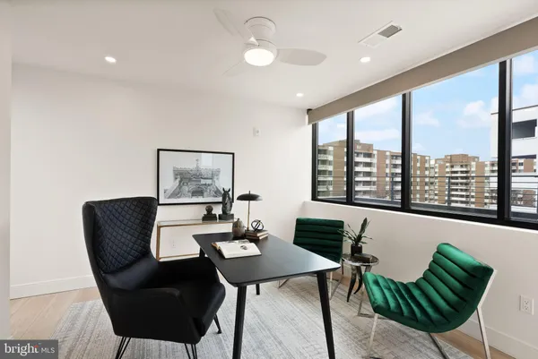 a view of a balcony with chairs and wooden fence