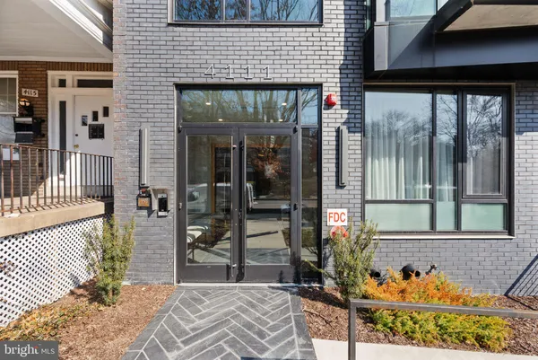 a bathroom with a glass shower door and mirror