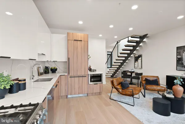 a living room with furniture and a kitchen