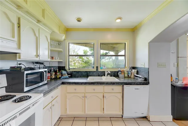 a kitchen with stainless steel appliances granite countertop a sink stove and cabinets