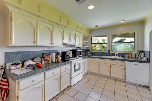 a kitchen with stainless steel appliances granite countertop a sink and cabinets