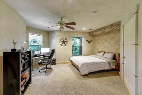 a bedroom with a bed gym equipment and a window