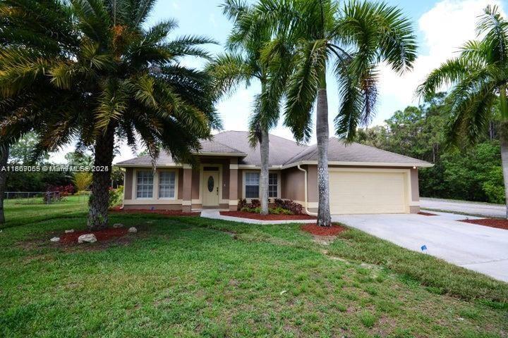 17569 North 89th Place North Loxahatchee, FL 33470 - Photo 2 of 24 a front view of a house with garden