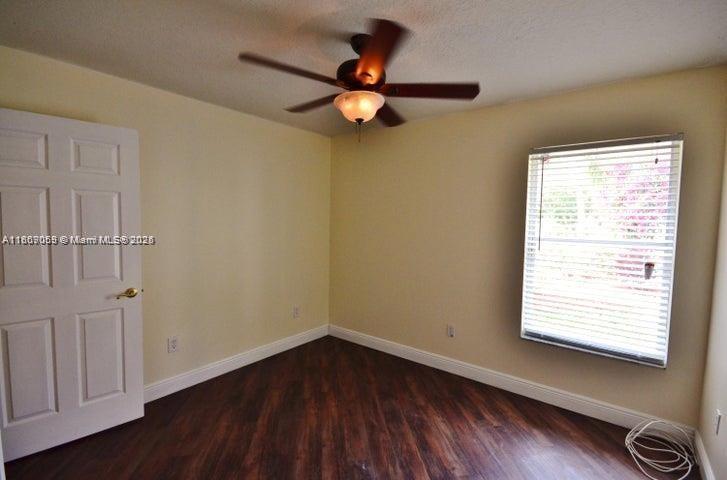 17569 North 89th Place North Loxahatchee, FL 33470 - Photo 21 of 24 a view of empty room with wooden floor and fan