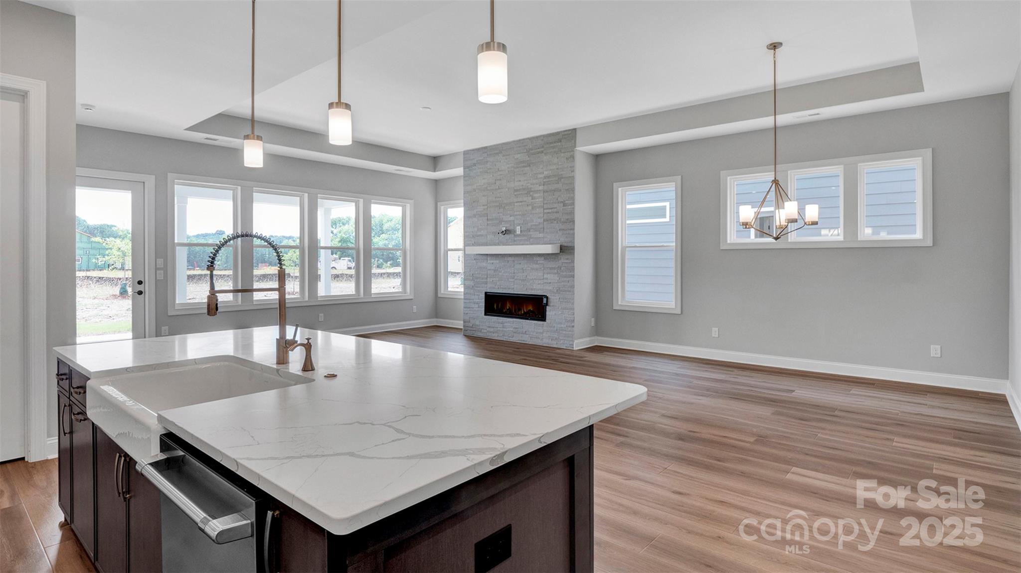 1031 Rabbit Hl Lane Monroe, NC 28110 - Photo 11 of 47 a dining room with wooden floor a chandelier a wooden table and chairs