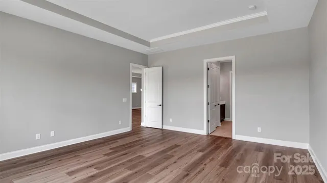 a view of an empty room and wooden floor