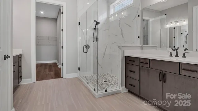 a bathroom with a double vanity sink toilet and shower