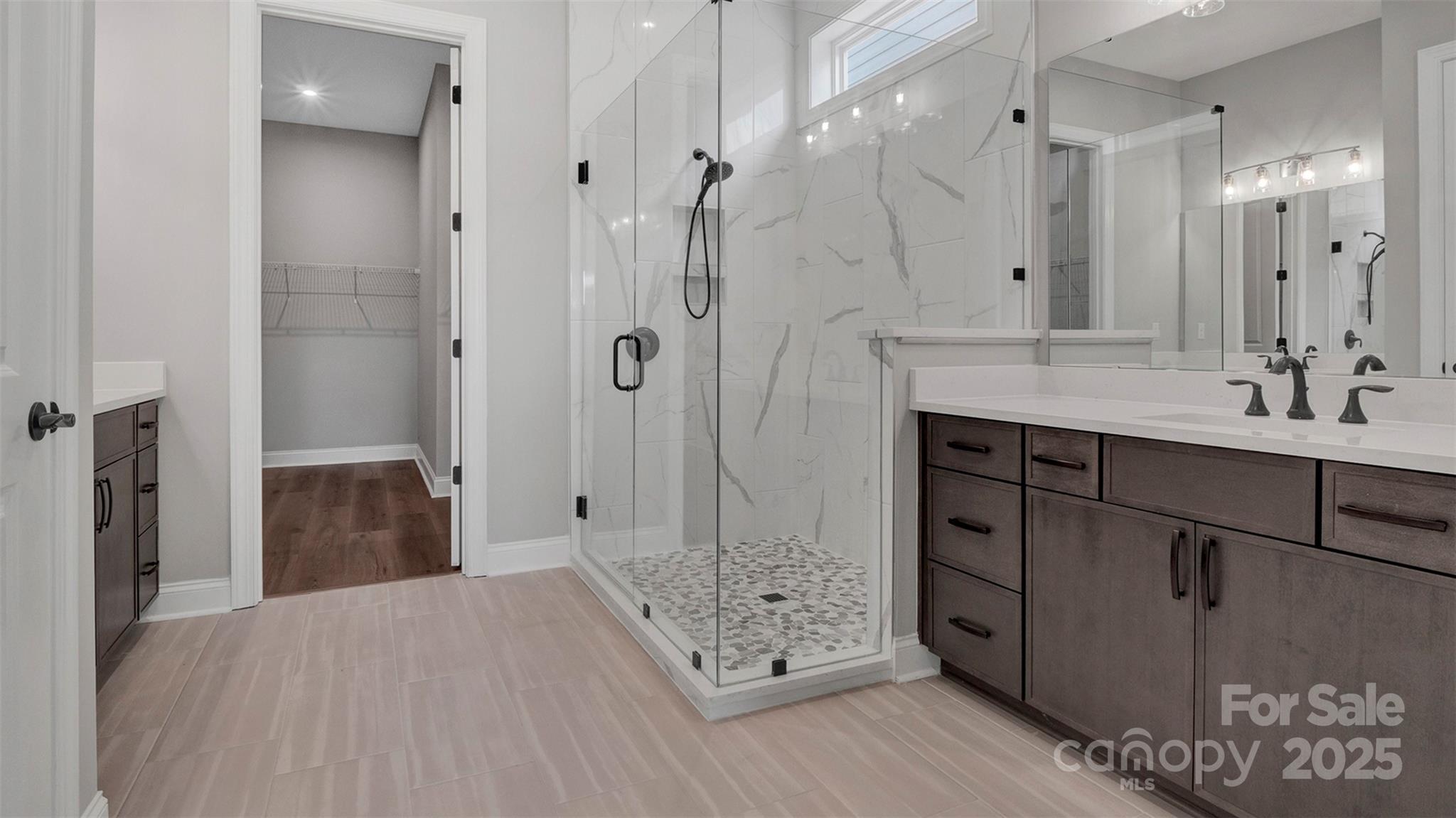 1031 Rabbit Hl Lane Monroe, NC 28110 - Photo 16 of 47 a bathroom with a double vanity sink toilet and shower