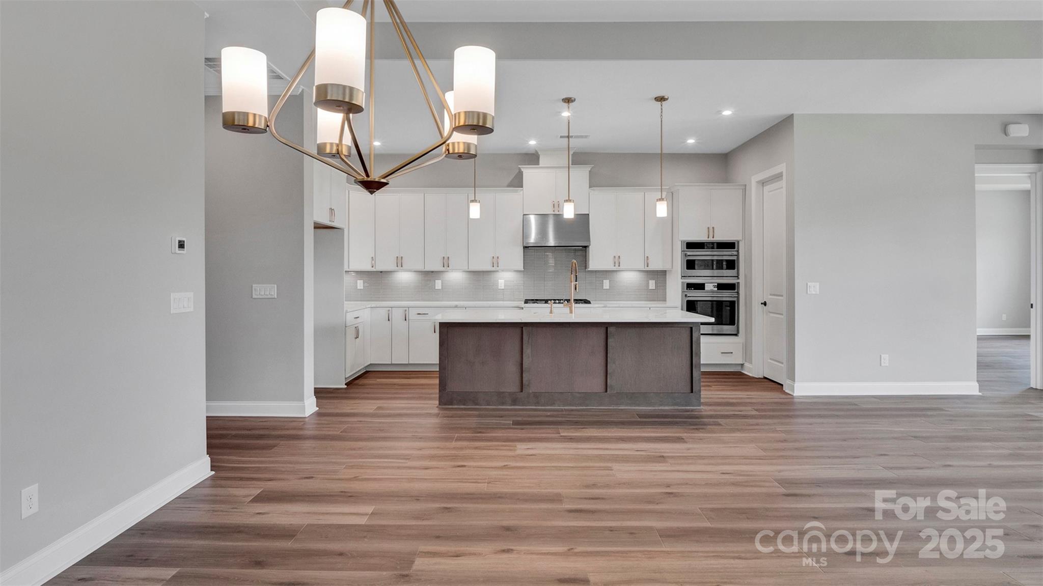 1031 Rabbit Hl Lane Monroe, NC 28110 - Photo 18 of 47 a large kitchen with stainless steel appliances kitchen island a large counter space a sink refrigerator and cabinets