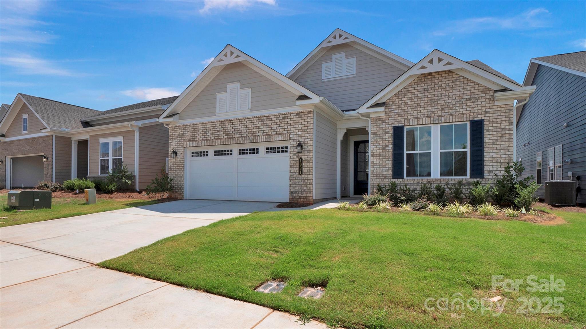 1031 Rabbit Hl Lane Monroe, NC 28110 - Photo 2 of 47 a front view of a house with a yard and garage