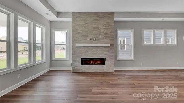 wooden floor in an empty room with a fireplace