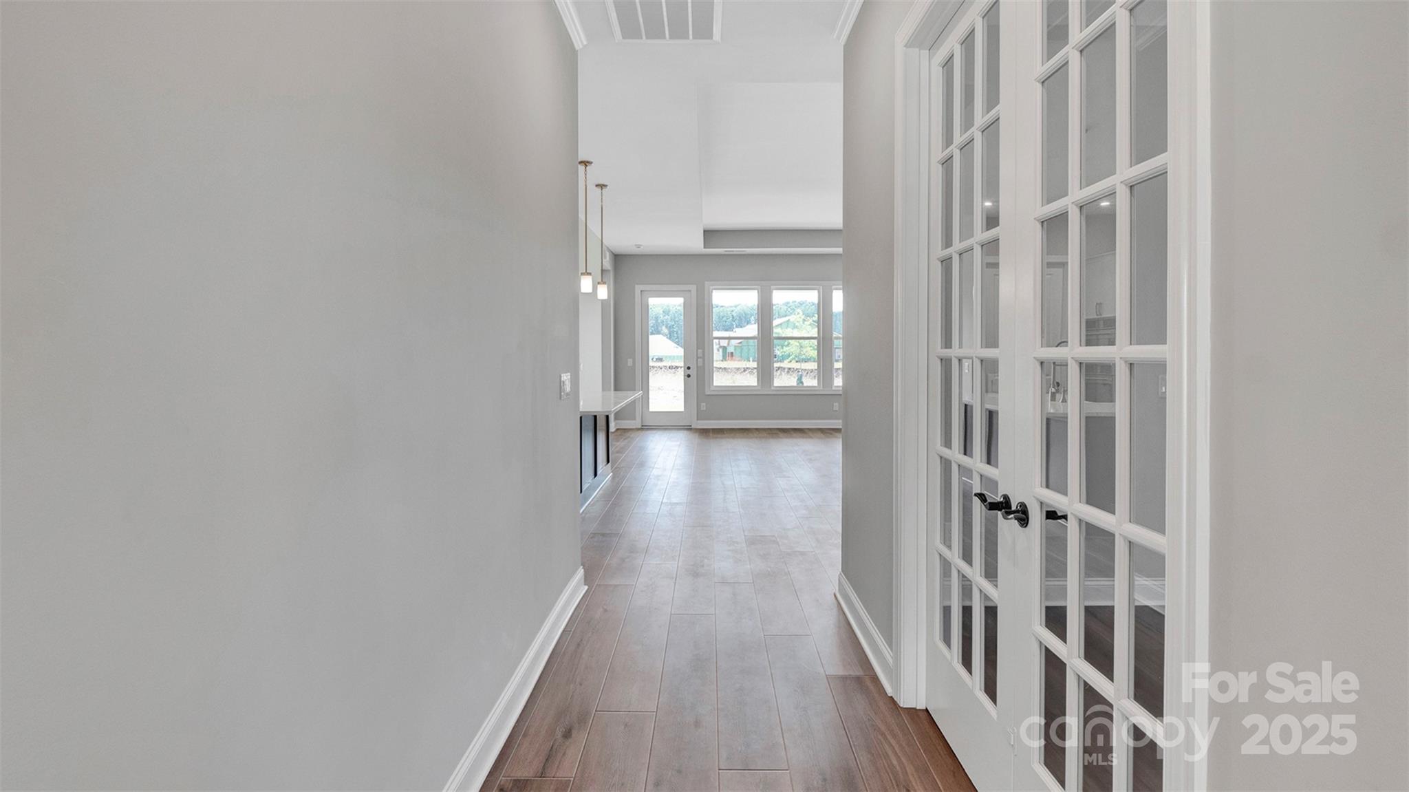 1031 Rabbit Hl Lane Monroe, NC 28110 - Photo 24 of 47 a view of a hallway with wooden floor and staircase