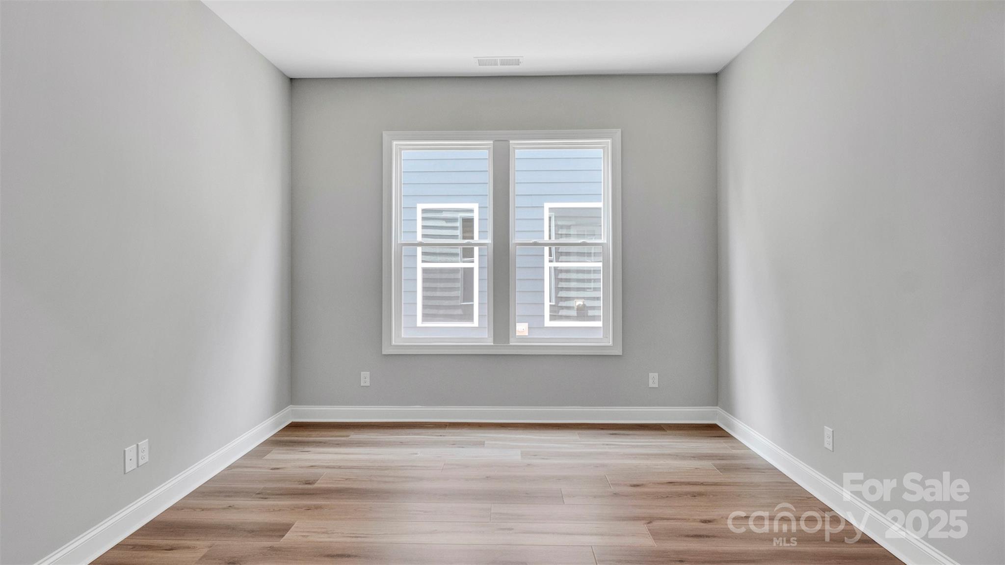 1031 Rabbit Hl Lane Monroe, NC 28110 - Photo 26 of 47 an empty room with wooden floor and windows