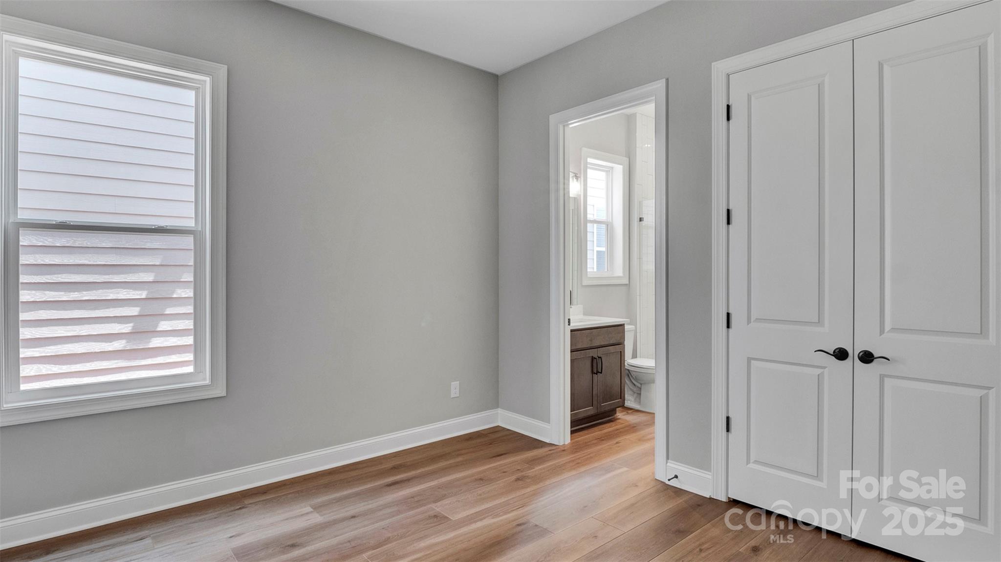 1031 Rabbit Hl Lane Monroe, NC 28110 - Photo 28 of 47 an empty room with wooden floor and closet area