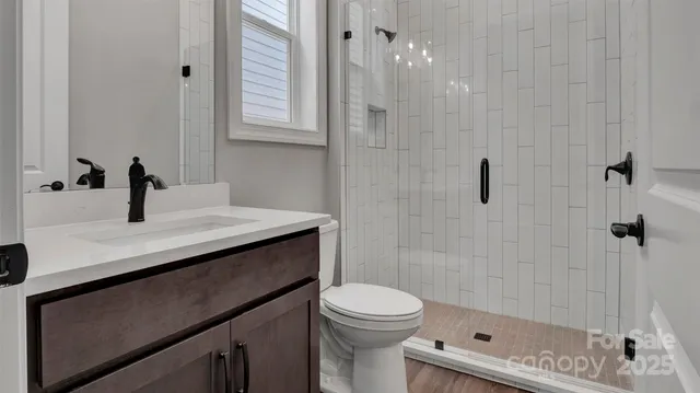 a view of a room with wooden floor and white walls