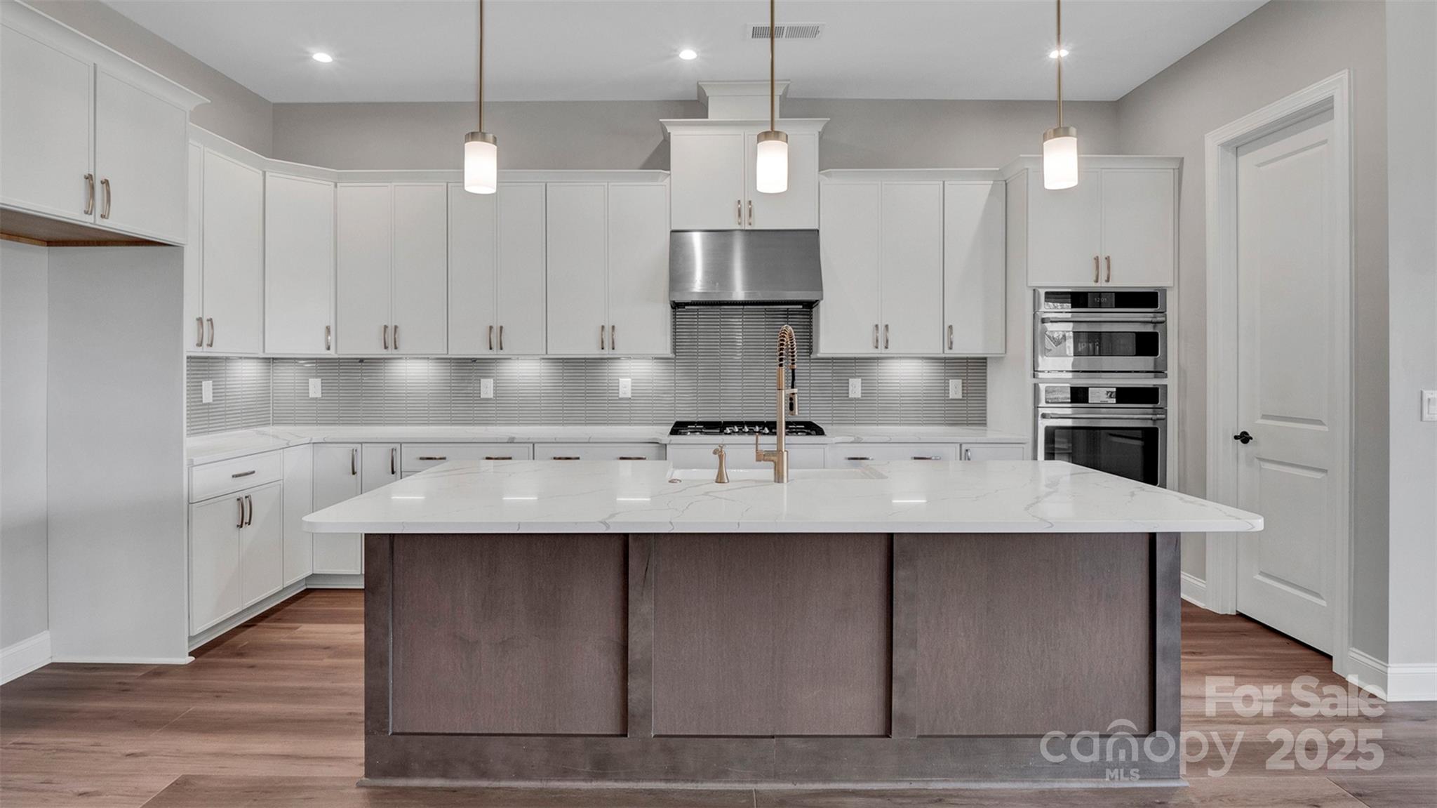 1031 Rabbit Hl Lane Monroe, NC 28110 - Photo 6 of 47 a kitchen with kitchen island granite countertop a sink a center island and cabinets