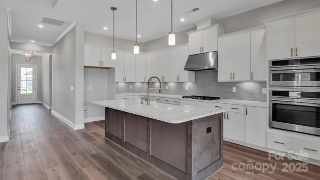 a kitchen with a sink stainless steel appliances and cabinets