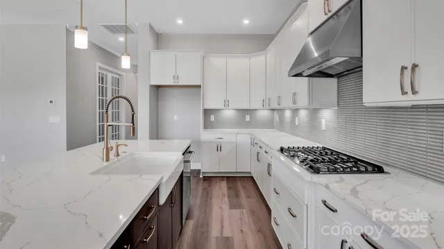 a kitchen with a sink stainless steel appliances and cabinets