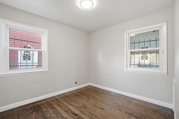 263 Taft Street Gary, IN 46404 - Photo 4 of 13 a view of an empty room with wooden floor and windows