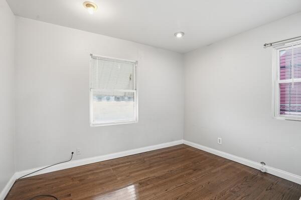 263 Taft Street Gary, IN 46404 - Photo 5 of 13 an empty room with wooden floor and windows