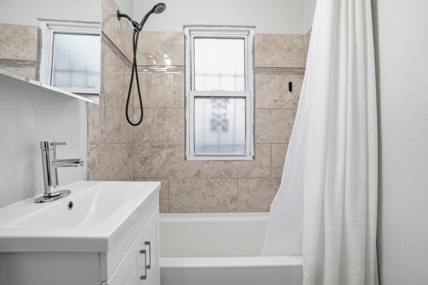 263 Taft Street Gary, IN 46404 - Photo 6 of 13 a bathroom with a sink a mirror and a bathtub