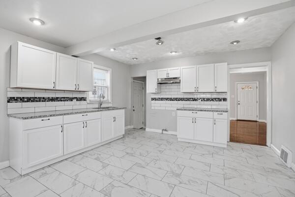 263 Taft Street Gary, IN 46404 - Photo 7 of 13 a kitchen with white cabinets and appliances