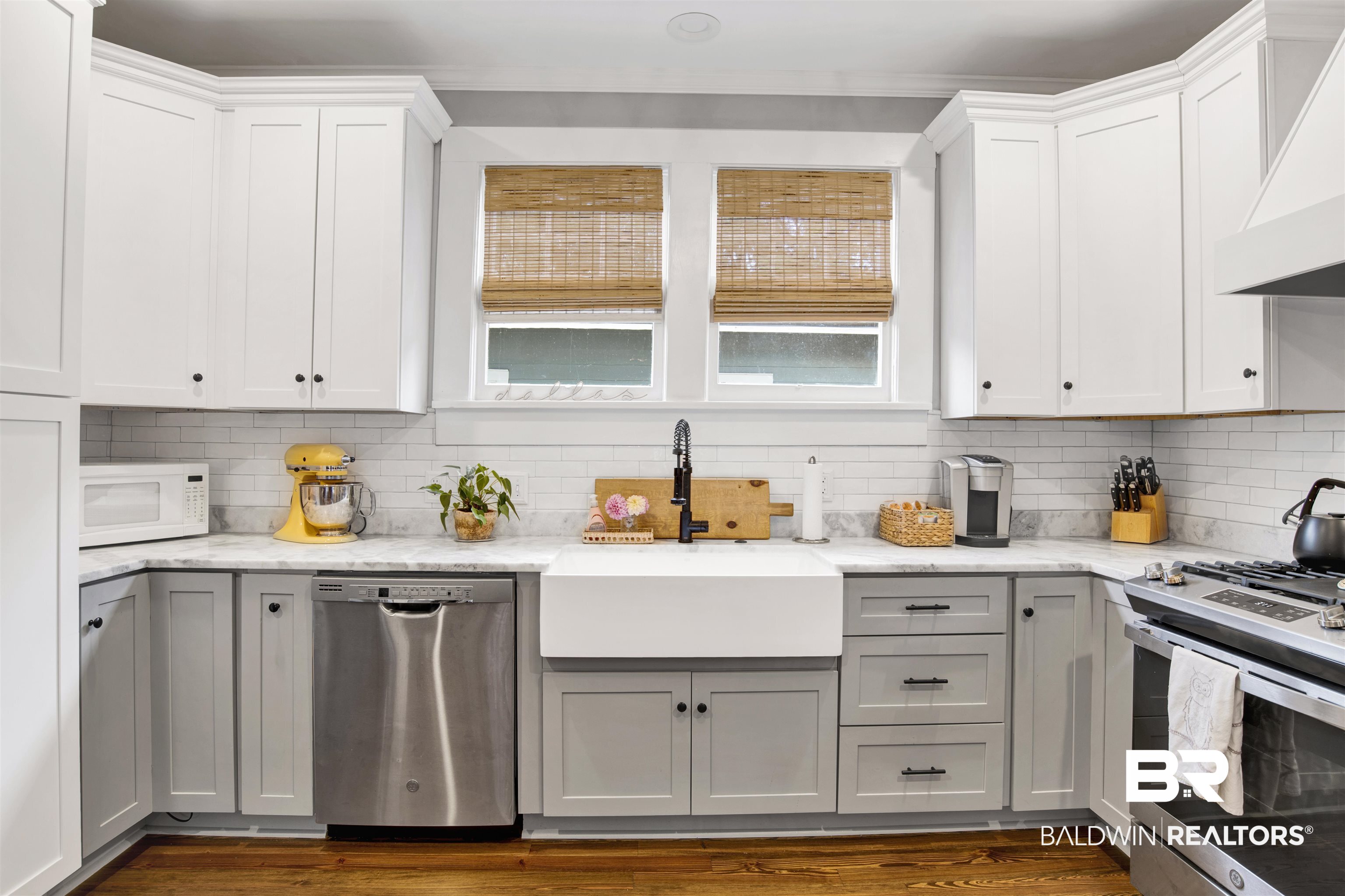 123 Macy Place Mobile, AL 36604 - Photo 10 of 35 Kitchen with stainless steel appliances, light stone countertops, dual tone cabinetry, tasteful backsplash, and dark wood-type flooring