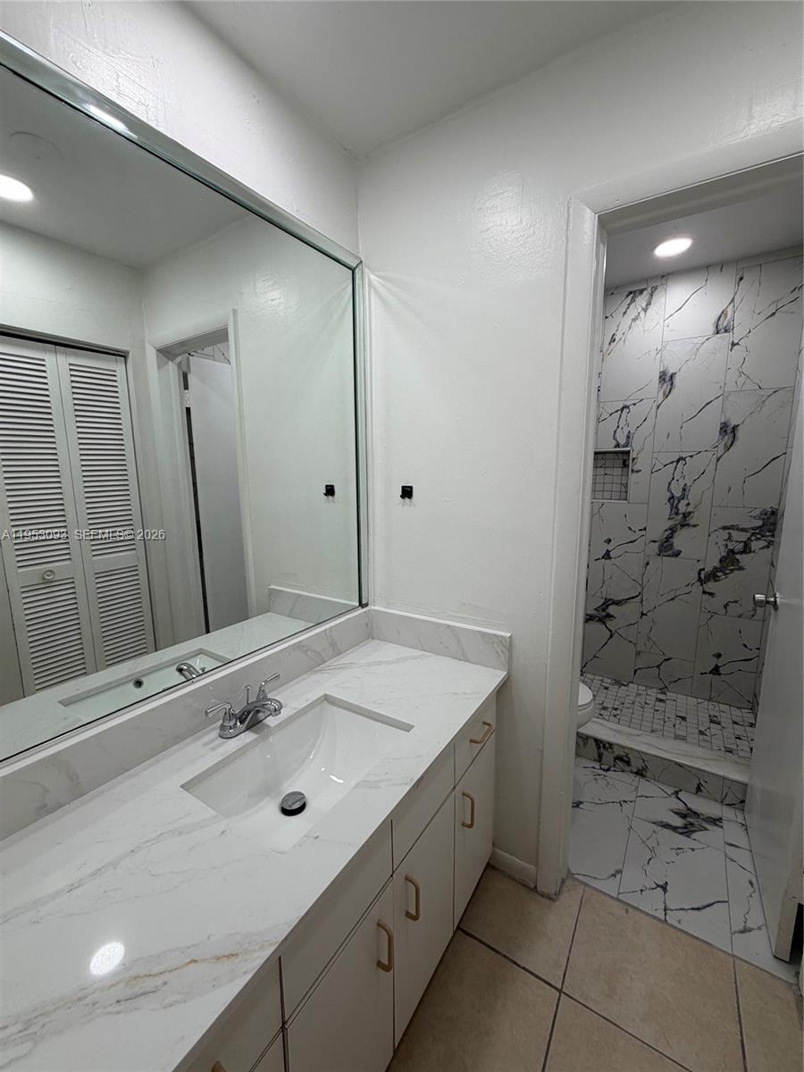 9503 Southwest 88th Terrace, Unit 9503 Miami, FL 33176 - Photo 8 of 15 a bathroom with a sink vanity and shower