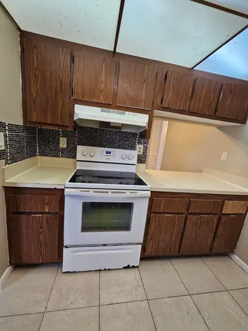 a kitchen with granite countertop a sink and a stove