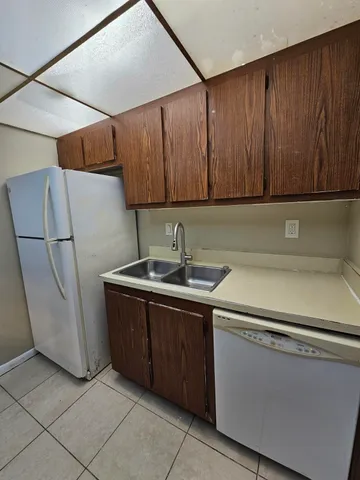 a kitchen with a sink and a refrigerator