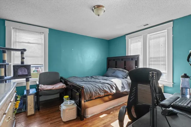 a bedroom with furniture and a window