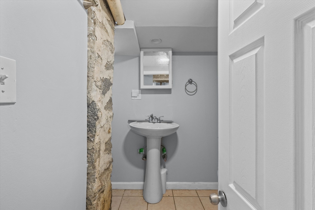 81 5th Avenue Lowell, MA 01854 - Photo 19 of 35 a bathroom with a sink and toilet