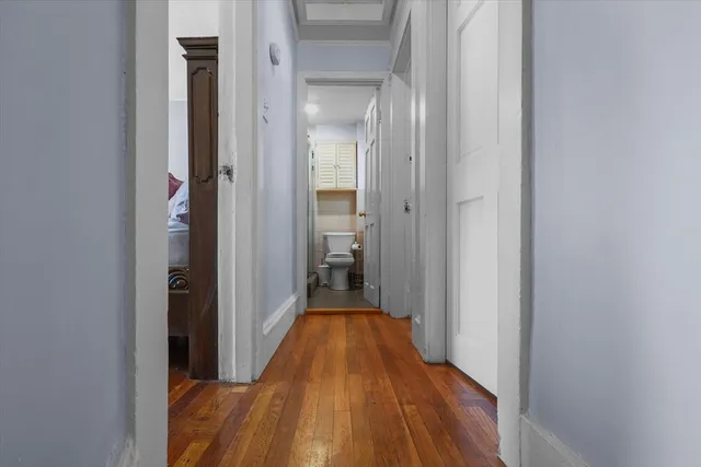 a view of a hallway with wooden floor