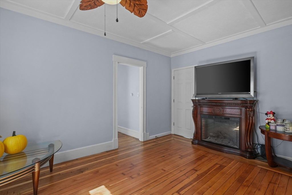81 5th Avenue Lowell, MA 01854 - Photo 9 of 35 a living room with furniture and a fireplace or television