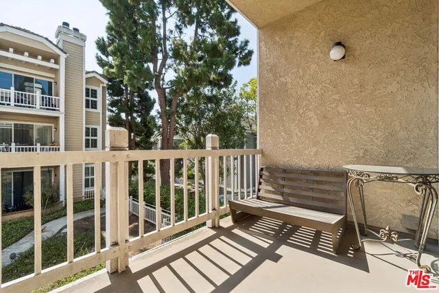 a view of a balcony with wooden floor