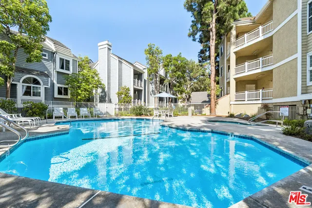 a swimming pool with outdoor seating and yard