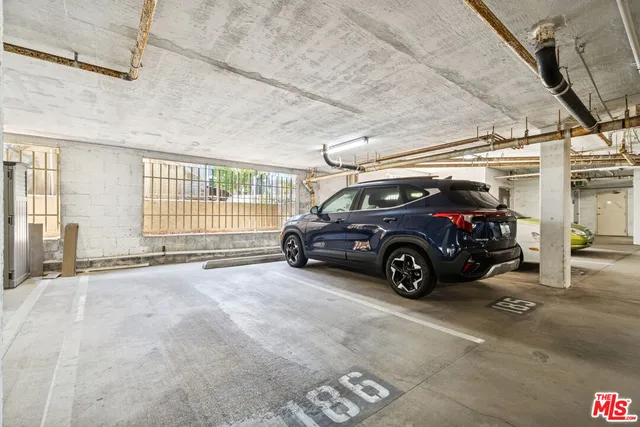 a view of parking garage with cars parked