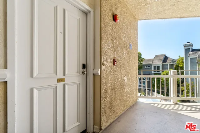 a view of a balcony with wooden floor and fence