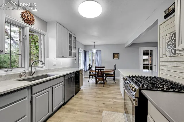 a kitchen with sink stove and cabinets