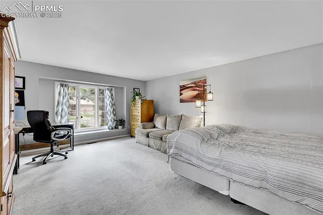 a bedroom with bed and a window