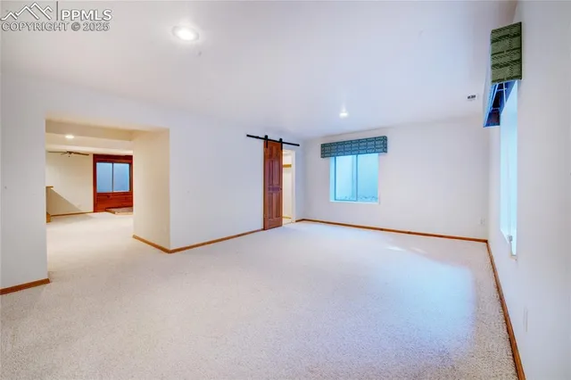 an empty room with windows and closet