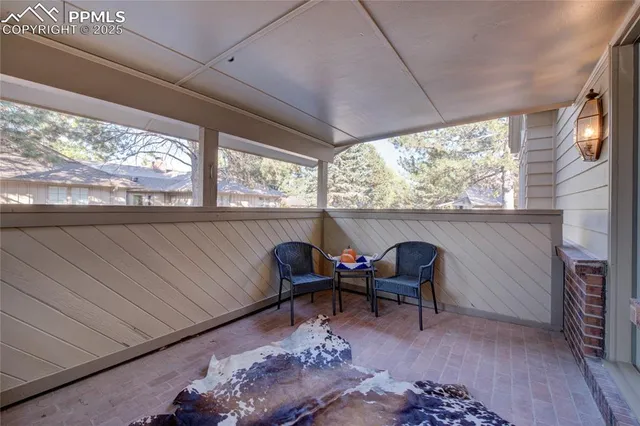 a view of a large building with a garden and pathway