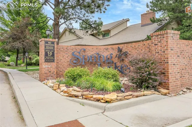 a street view with residential house and green space