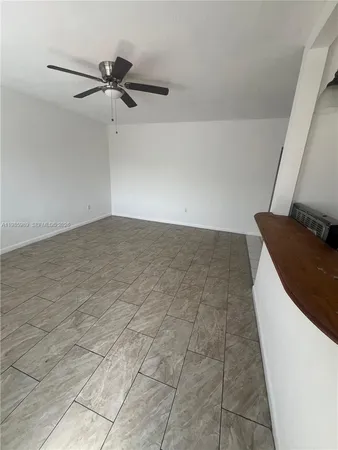 a view of a room with a sink and cabinets